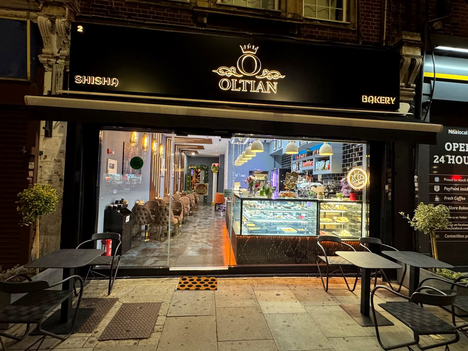 Oltian Shisha & Bakery storefront at 2 Watford Way, Hendon, at night